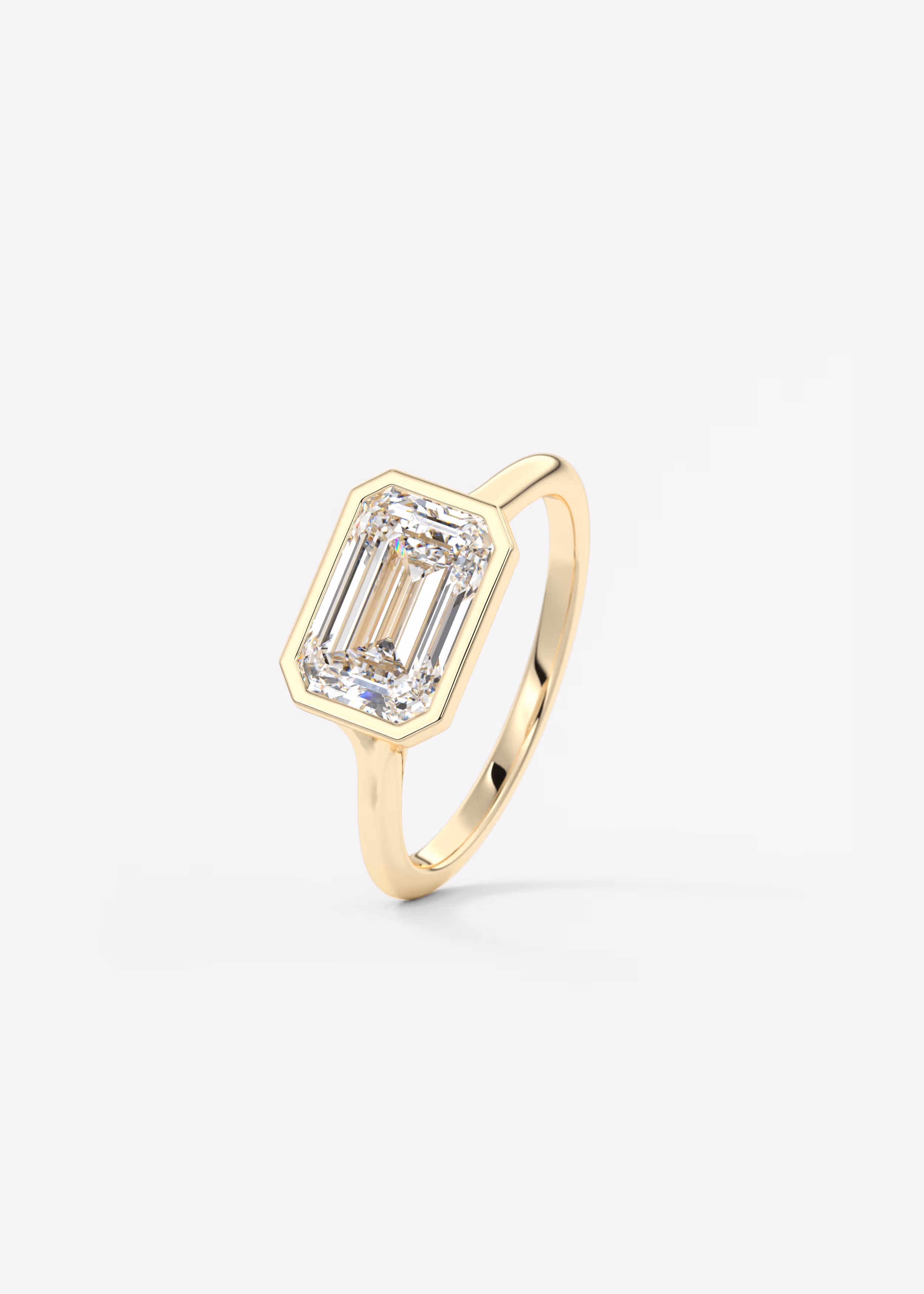 Floating east west emerald cut bezel Frank Darling diamond engagement ring yellow gold