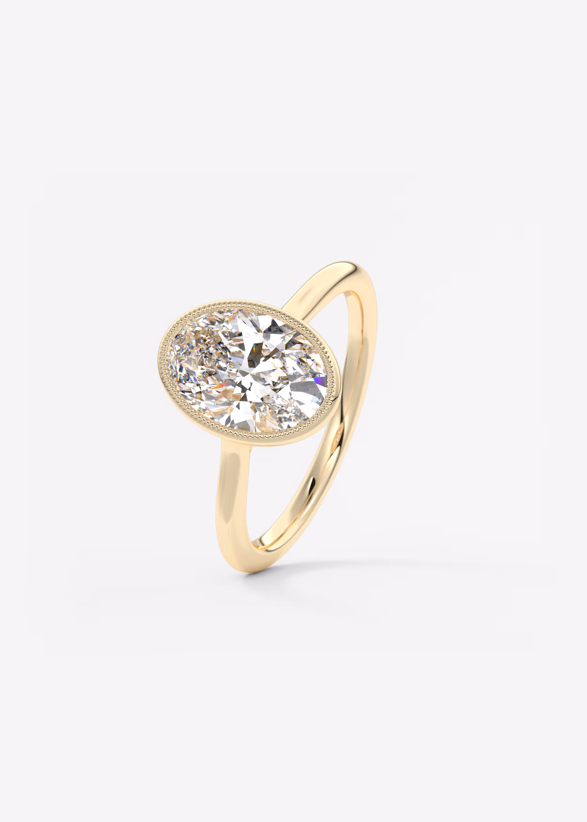 Vintage inspired oval bezel set Frank Darling diamond engagement ring with millgrain detailing and a low profile trellis basket in yellow gold